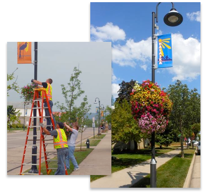 Centering Onalaska helps with flowering, hanging baskets and city flags hanging on historic lamp posts in downtown, Onalaska, Wisconsin.